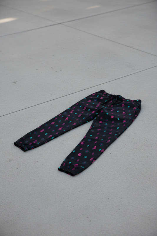 SUÐR Track Pants – Schwarz/Pink-Türkis
